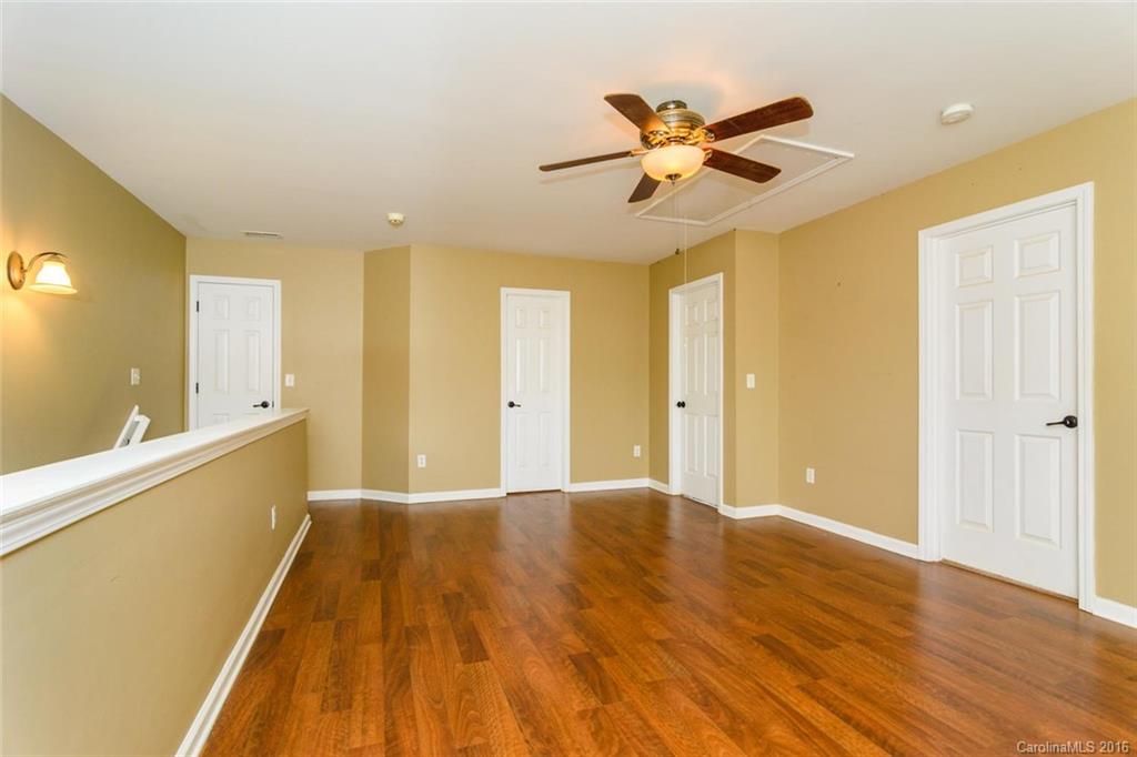 87 Yadkin Road, Unit 327 Fletcher, NC 28732 - Photo 21 of 23 a view of a livingroom with a ceiling fan and wooden floor