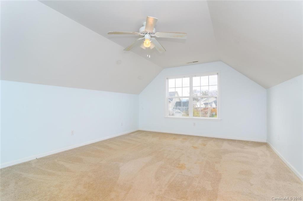 87 Yadkin Road, Unit 327 Fletcher, NC 28732 - Photo 23 of 23 an empty room with windows and chandelier fan