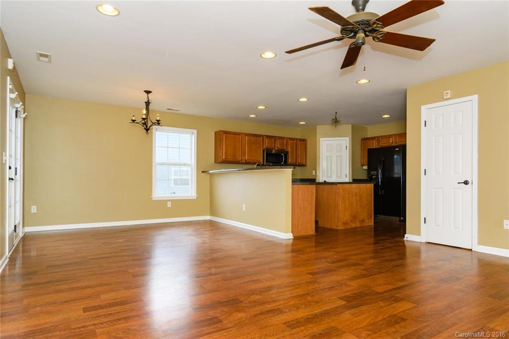 87 Yadkin Road, Unit 327 Fletcher, NC 28732 - Photo 6 of 23 a view of a kitchen with a refrigerator and a microwave