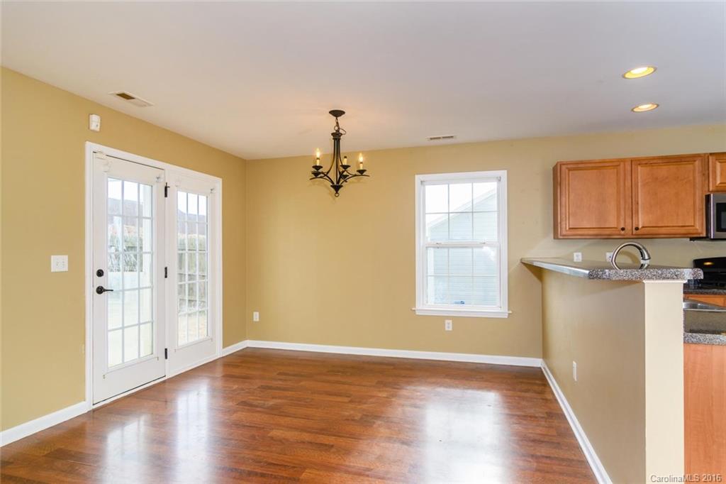 87 Yadkin Road, Unit 327 Fletcher, NC 28732 - Photo 8 of 23 a view of an empty room with wooden floor and a window