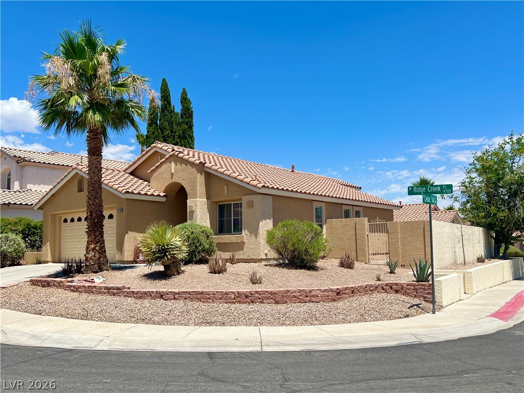 9708 Ridge Creek Place Las Vegas, NV 89134 - Photo 4 of 34 A desert-friendly landscape surrounds this corner residence with an inviting curb appeal.