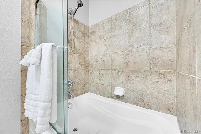 a bathroom with a bathtub and shower