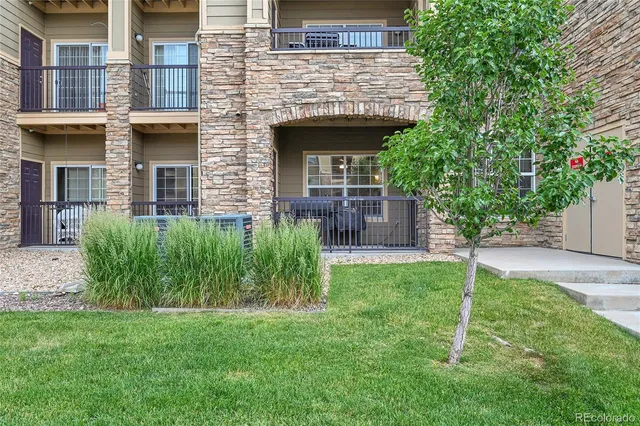 a view of a house with a yard and plants