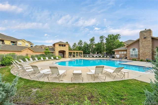 a view of a house with a big yard and sitting area