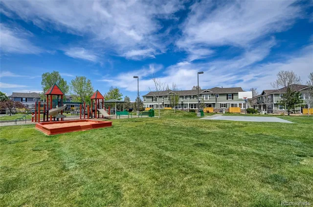 a childrens park with lots of swings and slides