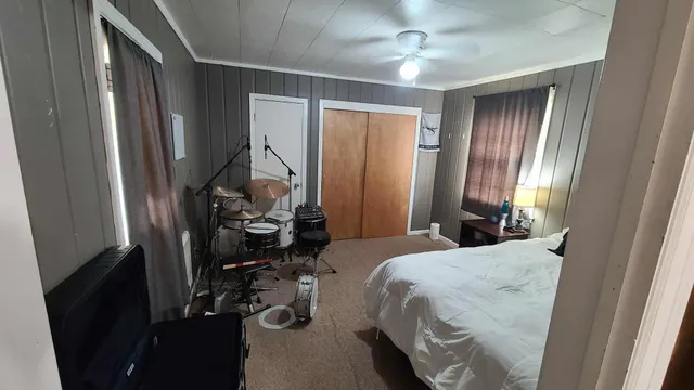 a bedroom with a bed and a mirror