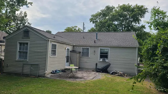 a view of a small house and a yard