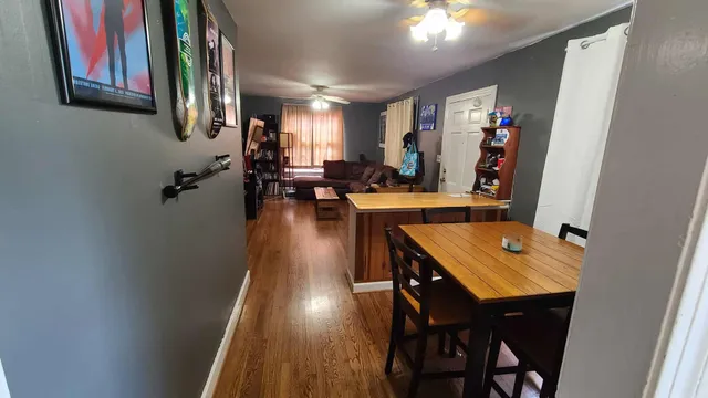 a view of a dining room with furniture and a chandelier