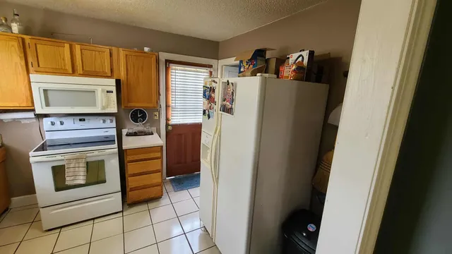a kitchen with a refrigerator and washer