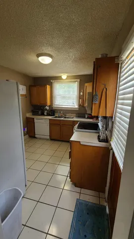 a kitchen with a sink cabinets and window
