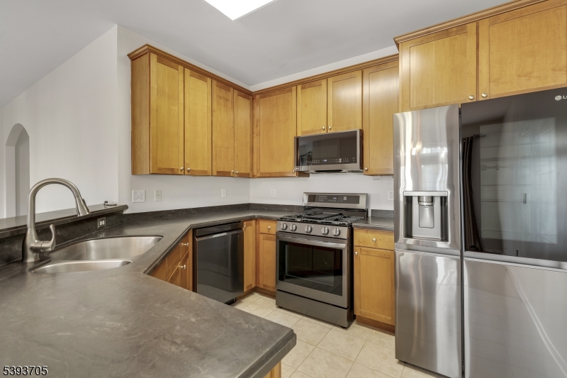 805 Deluca Road, Unit 805 Belleville, NJ 07109 - Photo 11 of 35 a kitchen with stainless steel appliances granite countertop a sink a stove and a refrigerator