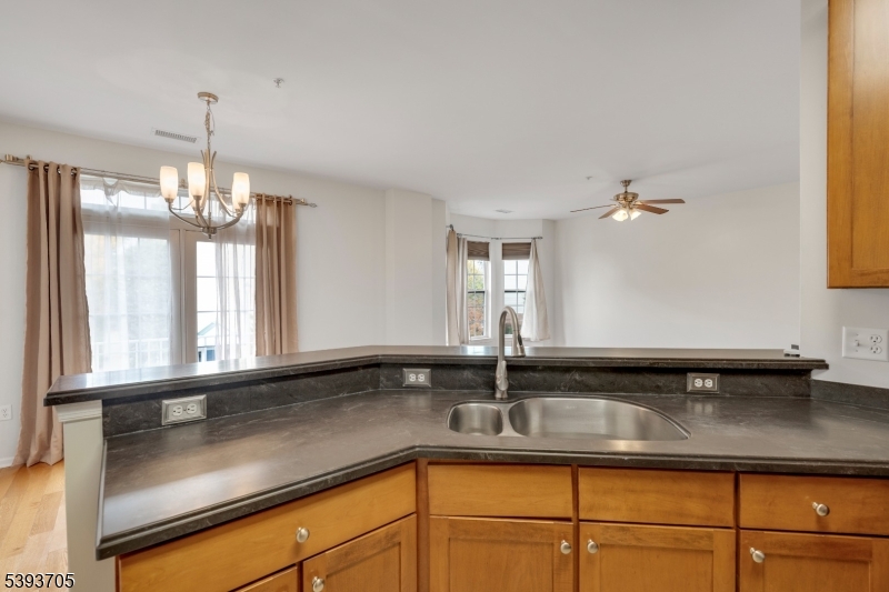 805 Deluca Road, Unit 805 Belleville, NJ 07109 - Photo 12 of 35 a kitchen with a sink and chandelier