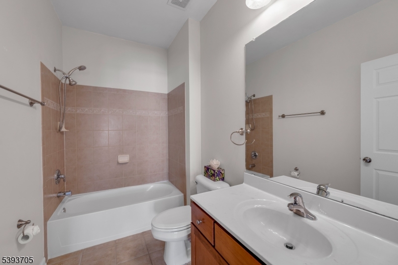 805 Deluca Road, Unit 805 Belleville, NJ 07109 - Photo 20 of 35 a bathroom with a bathtub shower sink vanity mirror and toilet