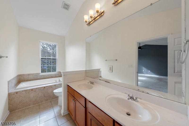 805 Deluca Road, Unit 805 Belleville, NJ 07109 - Photo 25 of 35 a bathroom with a sink a vanity and a bathtub