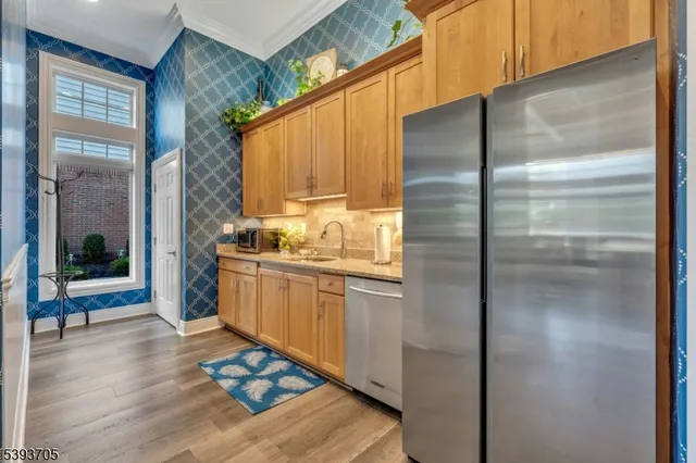 a kitchen with stainless steel appliances granite countertop a refrigerator and a stove