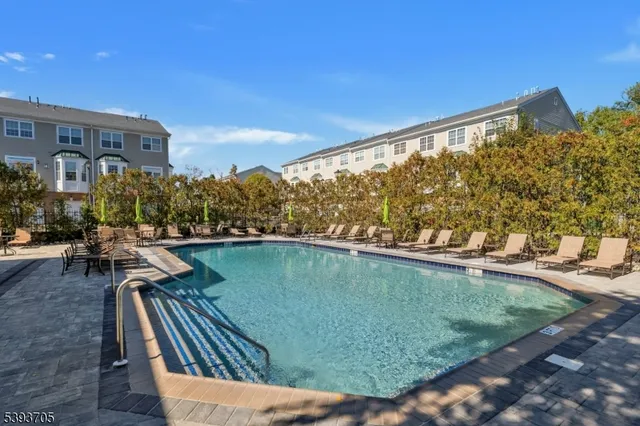 a view of swimming pool outdoor seating and city view