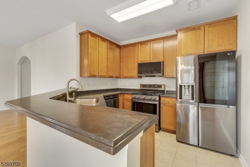 805 Deluca Road, Unit 805 Belleville, NJ 07109 - Photo 10 of 35 a kitchen with stainless steel appliances granite countertop a sink a stove and a refrigerator