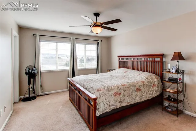 a bed sitting in a bedroom next to a window