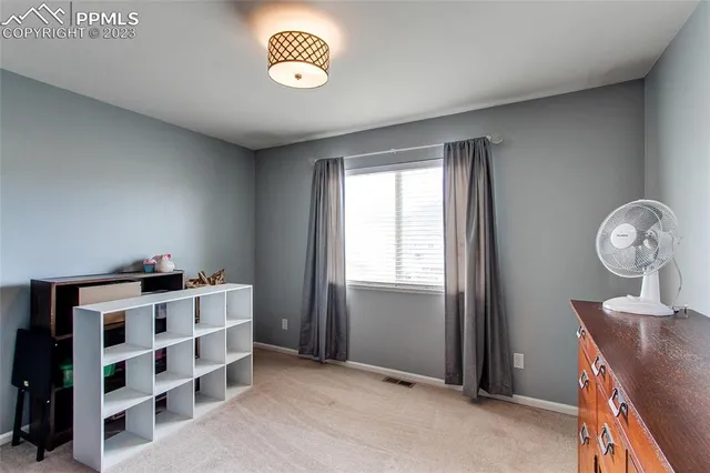 a view of kitchen with cabinets and window
