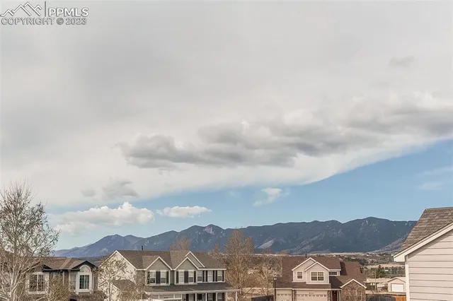 a view of a town with mountains in the background