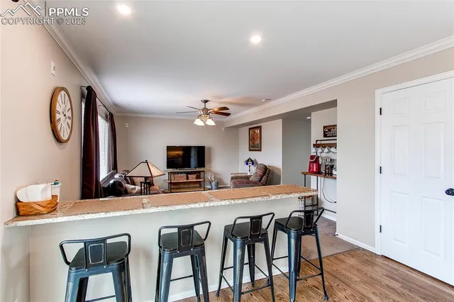 a dining hall with stainless steel appliances a table and chairs