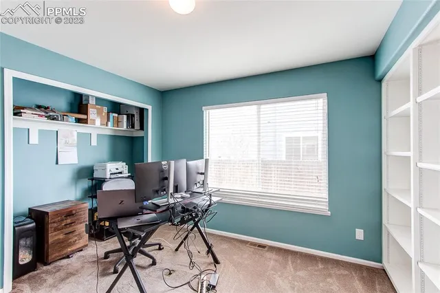 a workspace with furniture and a window