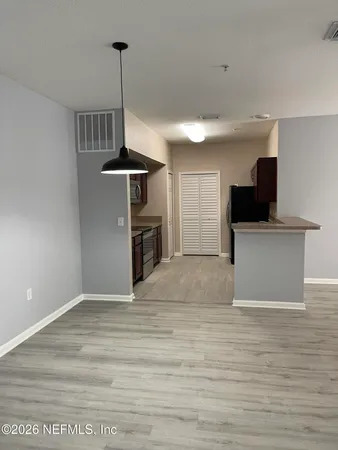 a view of a kitchen with furniture and a ceiling fan