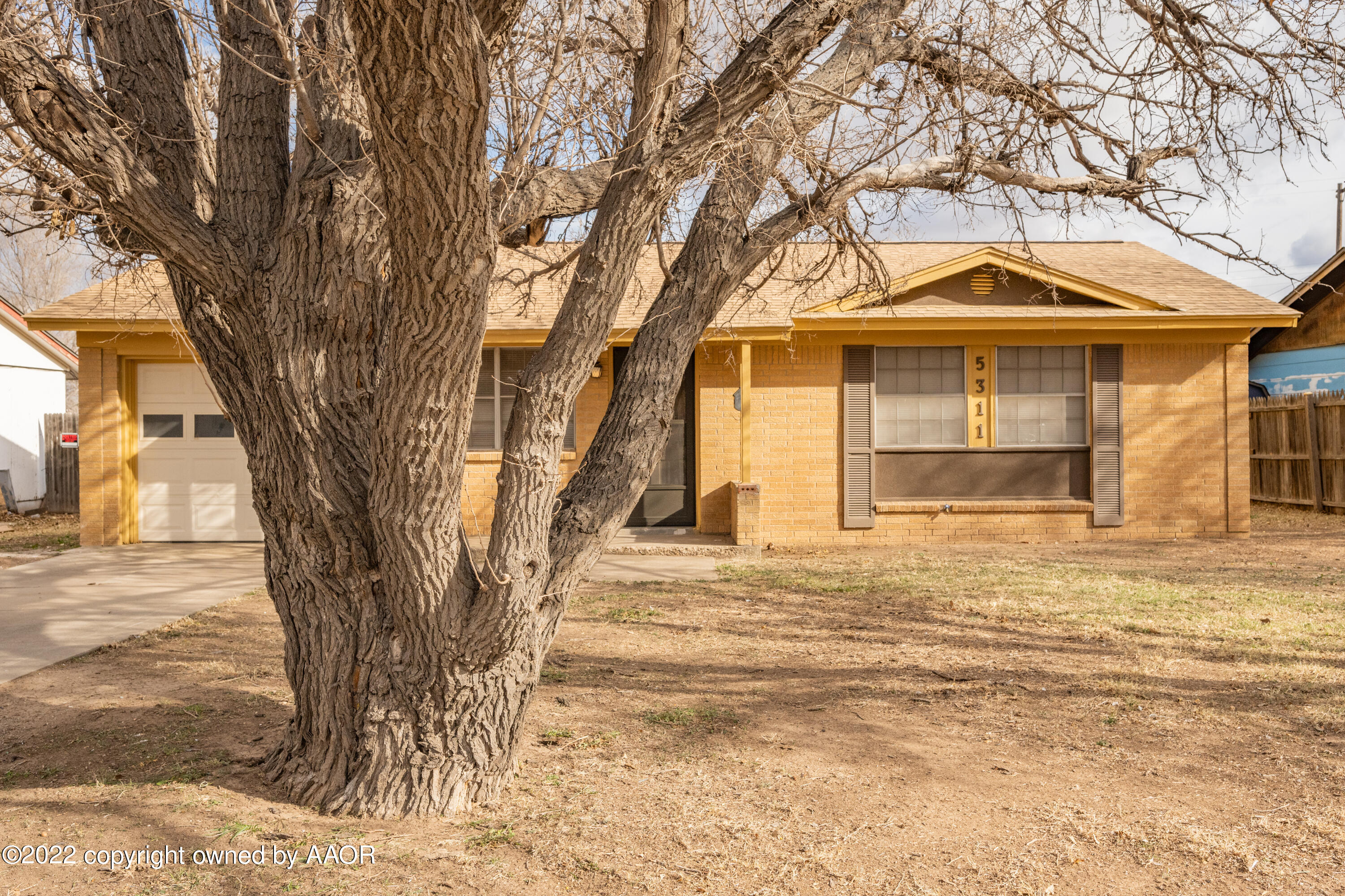 5311 Allen Street Amarillo, TX 79110 - Photo 4 of 22 a front view of a house with a yard