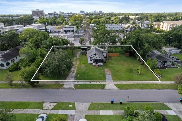 an aerial view of residential houses with outdoor space and street view