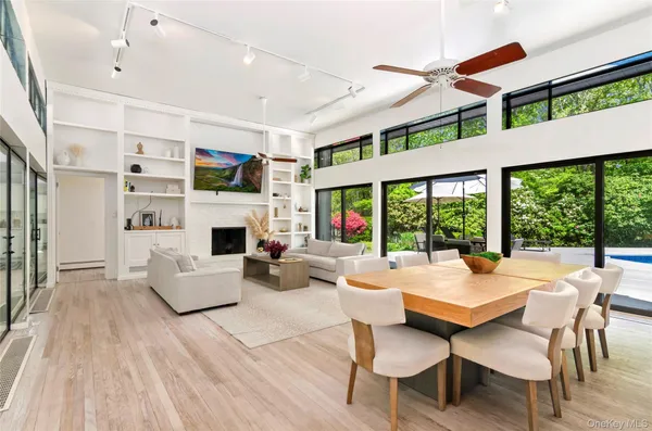 a living room with furniture fireplace and a large window