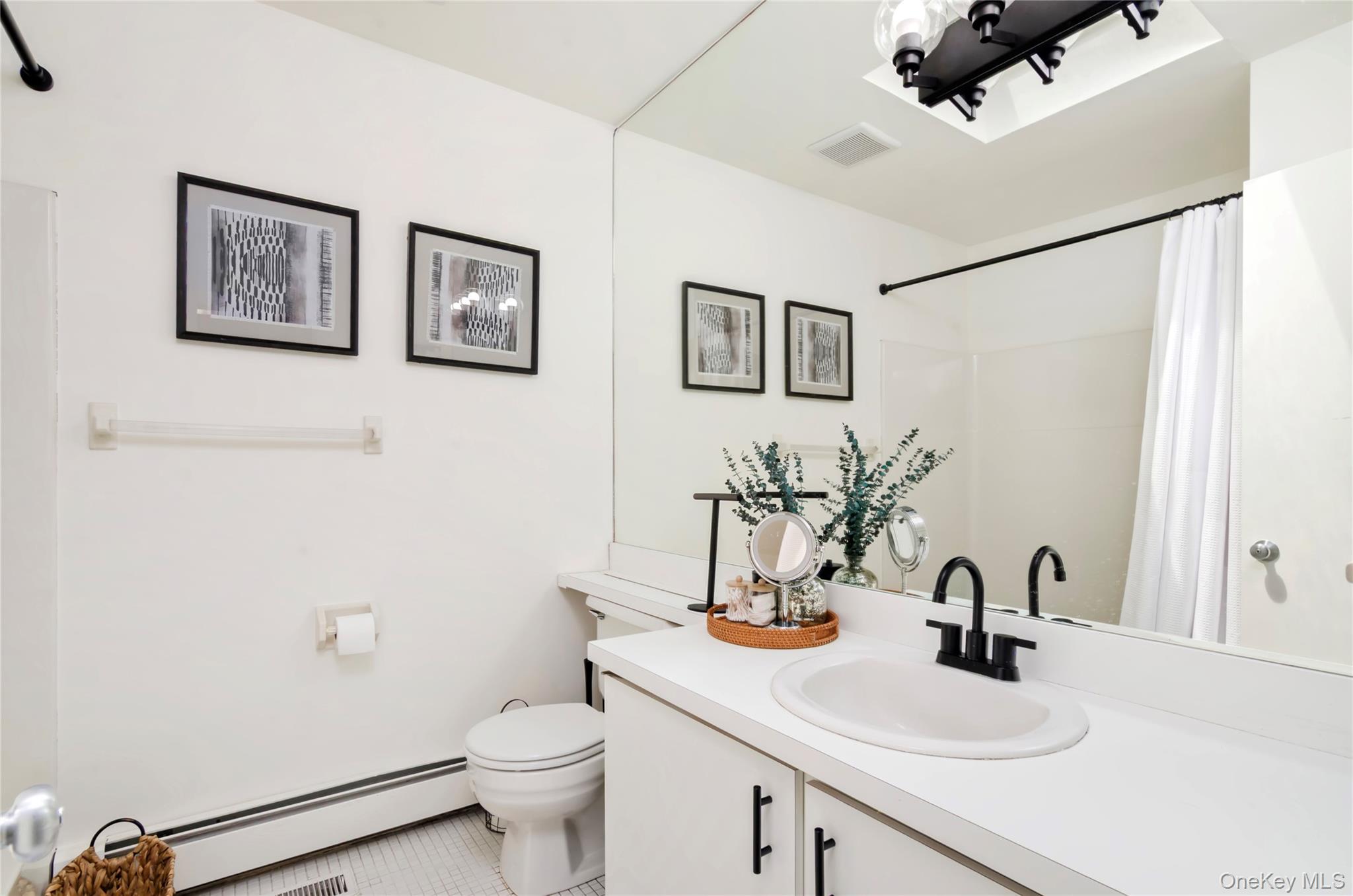 24 North Quarter Road Westhampton, NY 11977 - Photo 15 of 27 a bathroom with a sink toilet and a mirror