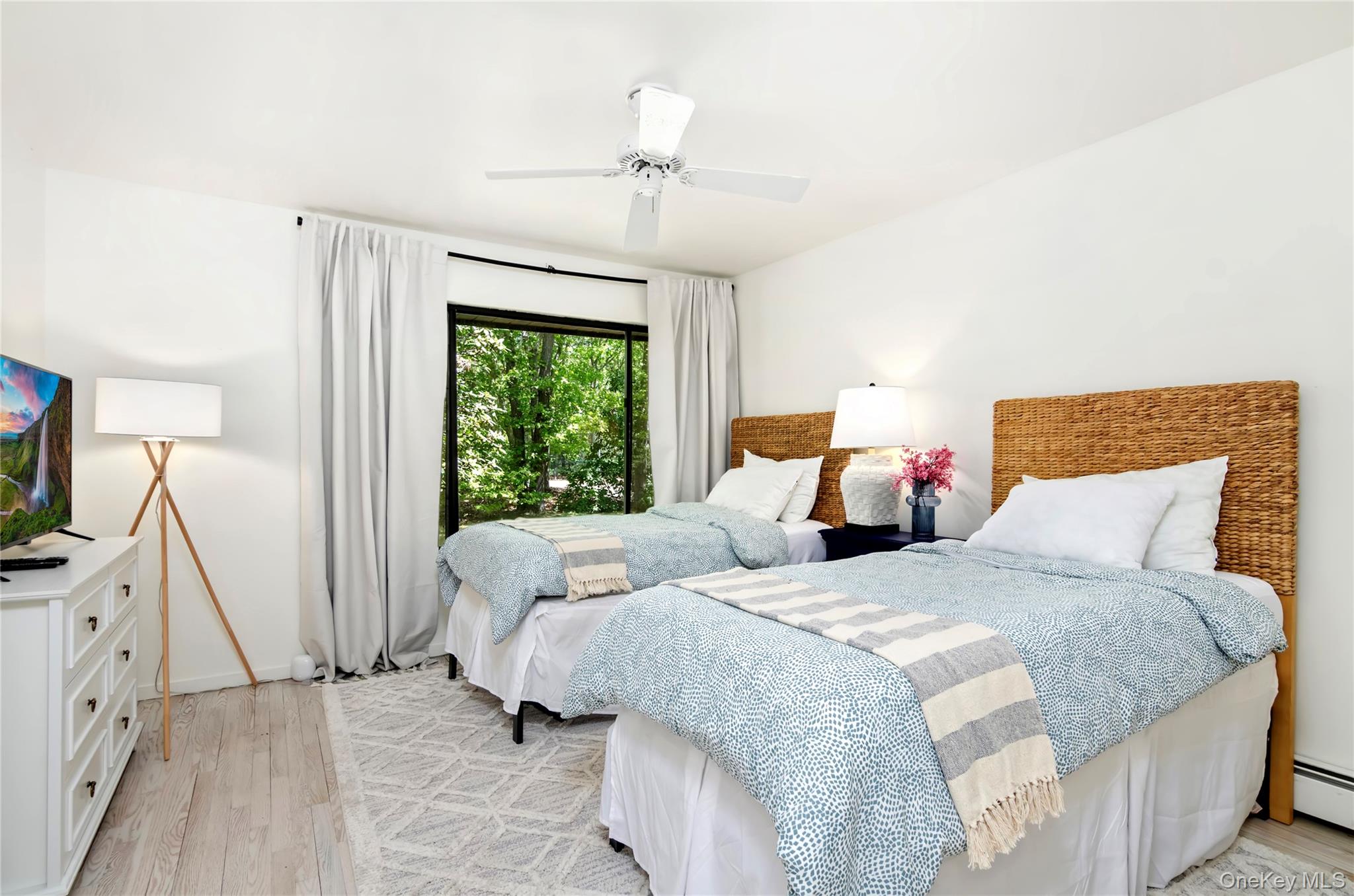 24 North Quarter Road Westhampton, NY 11977 - Photo 16 of 27 a bedroom with two beds and a chandelier