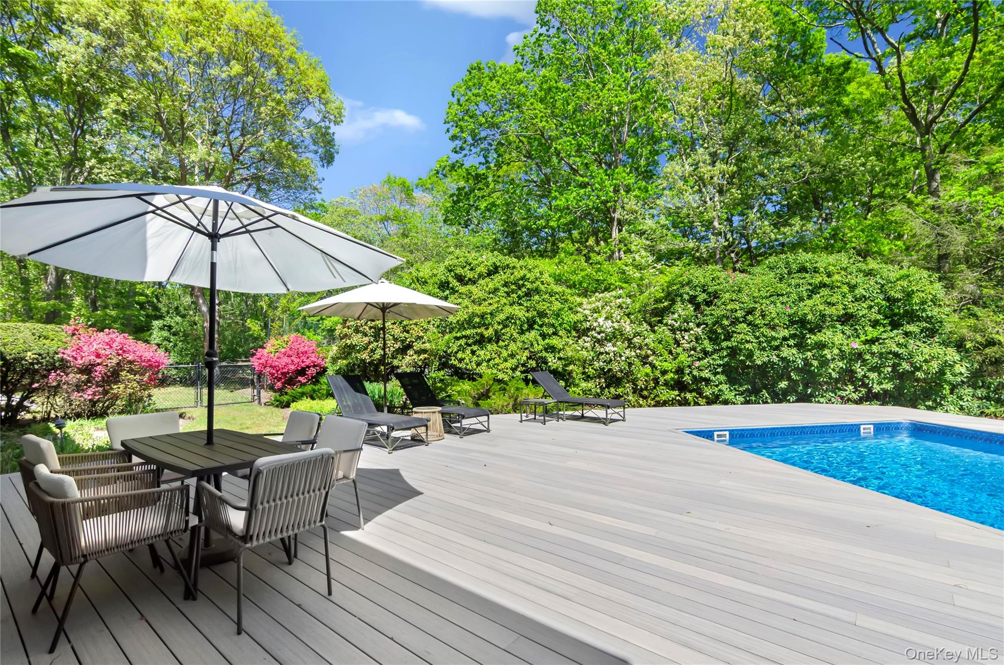 24 North Quarter Road Westhampton, NY 11977 - Photo 24 of 27 a view of a chairs and table under an umbrella