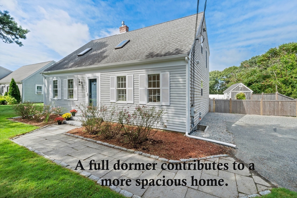 103 Williston Road Bourne, MA 02562 - Photo 1 of 40 a front view of a house with garden
