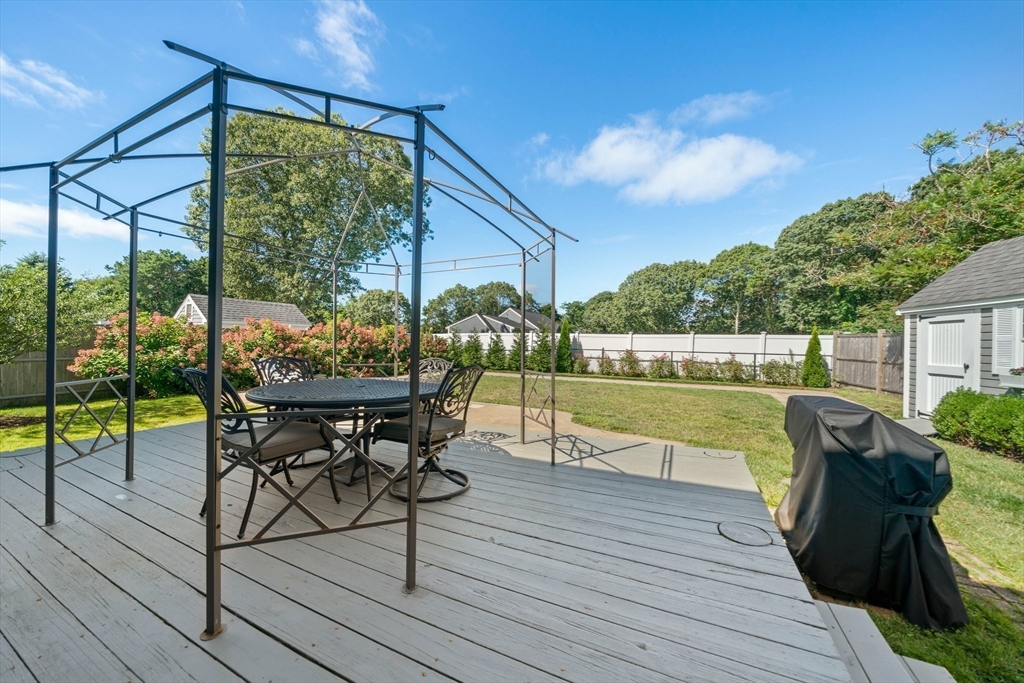 103 Williston Road Bourne, MA 02562 - Photo 29 of 40 a view of a chairs and table in patio with a lake view
