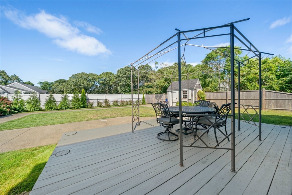 103 Williston Road Bourne, MA 02562 - Photo 30 of 40 a view of a deck with wooden floor table and chairs