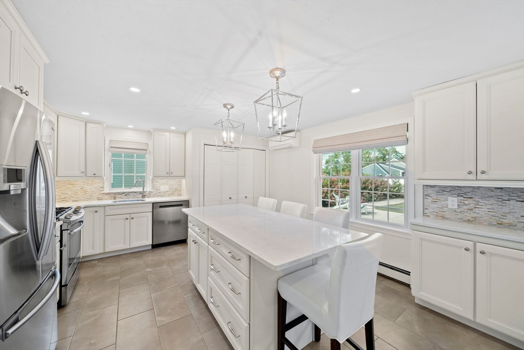 103 Williston Road Bourne, MA 02562 - Photo 3 of 40 a kitchen with a stove a sink a center island and a window