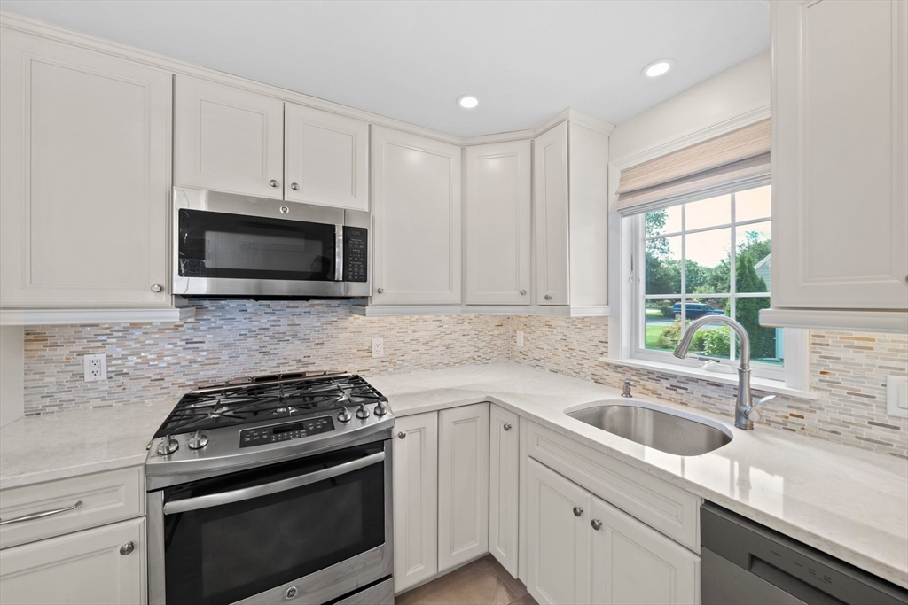 103 Williston Road Bourne, MA 02562 - Photo 6 of 40 a kitchen with a sink stove and microwave