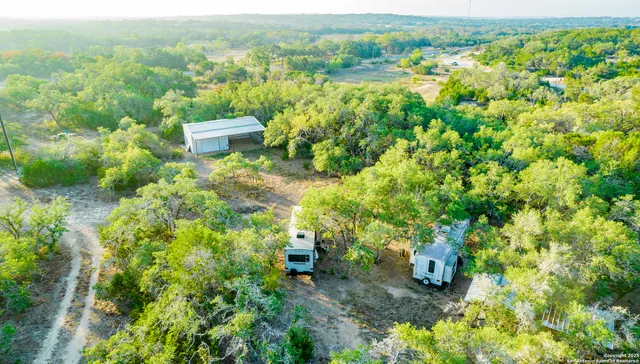 a view of a city with lush green forest