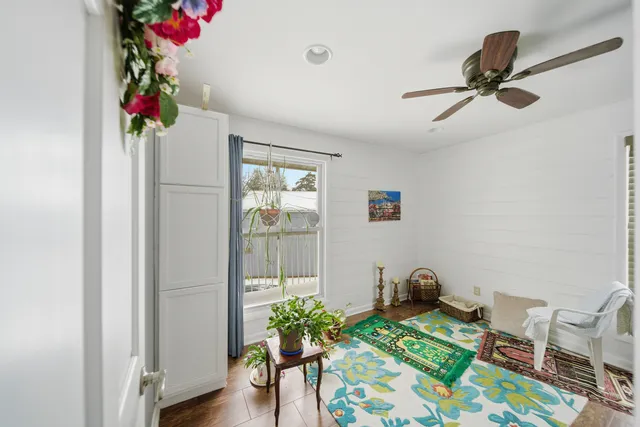 a bed room with furniture and a potted plant