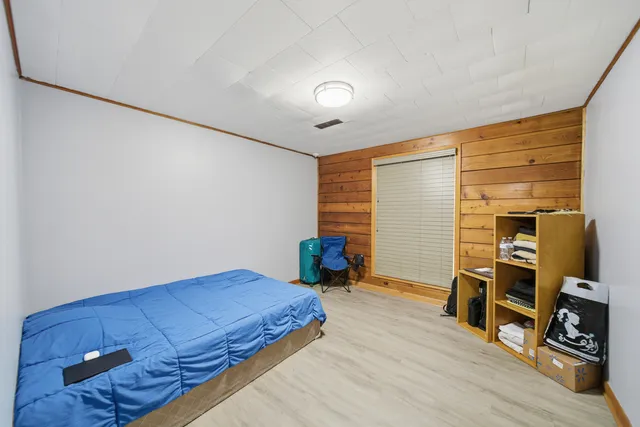 a bedroom with furniture and a wooden floor