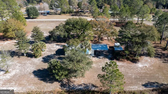 a view of a house with a yard and sitting area