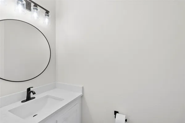 a bathroom with a sink and mirror