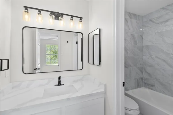 a bathroom with a bathtub and a sink