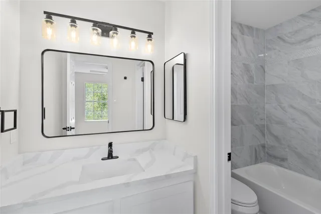 a bathroom with a bathtub and a sink