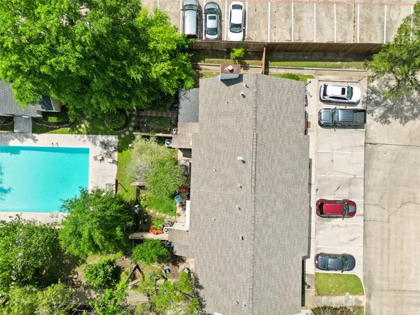 an aerial view of a house with swimming pool and garden view