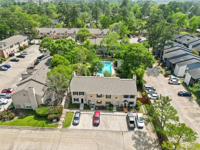an aerial view of a house with swimming pool and garden view