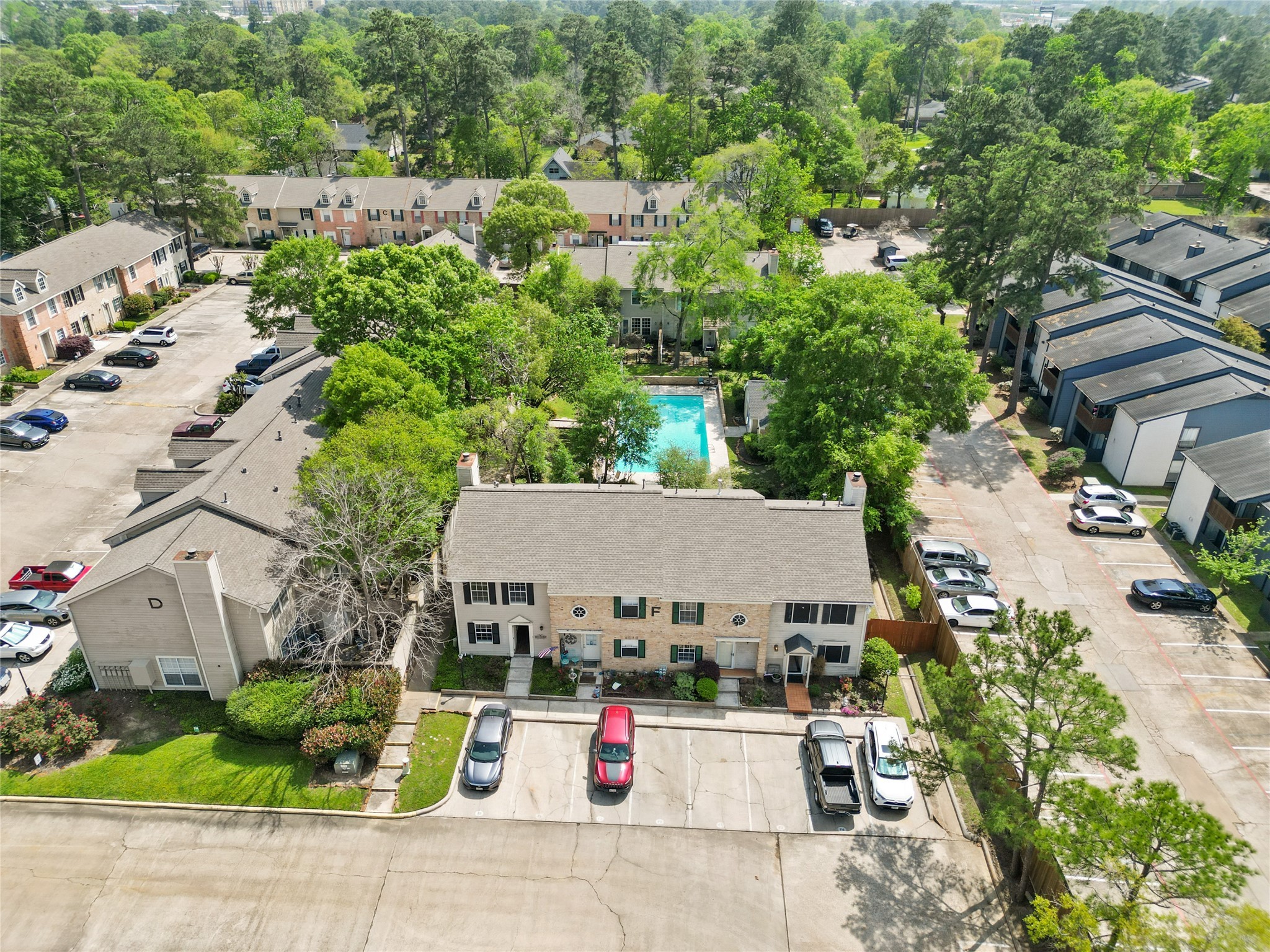 2030 Plantation Drive, Unit F3 Conroe, TX 77301 - Photo 20 of 22 an aerial view of a house with swimming pool and garden view