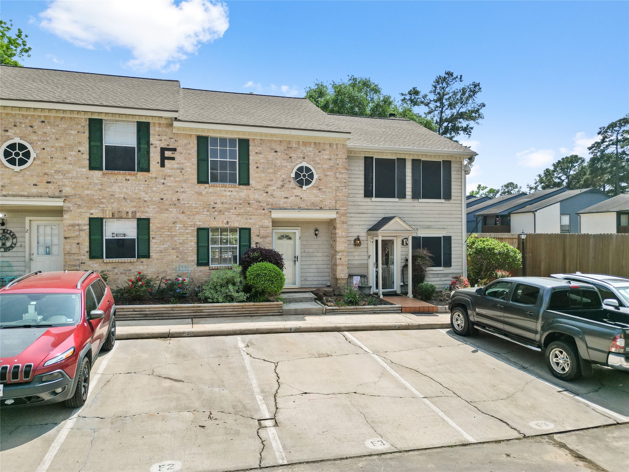 2030 Plantation Drive, Unit F3 Conroe, TX 77301 - Photo 2 of 22 a front view of a house with a yard