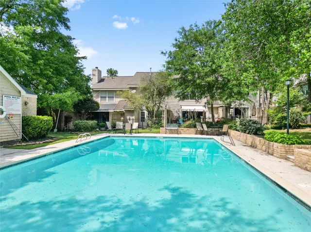 a view of an house with swimming pool and sitting area